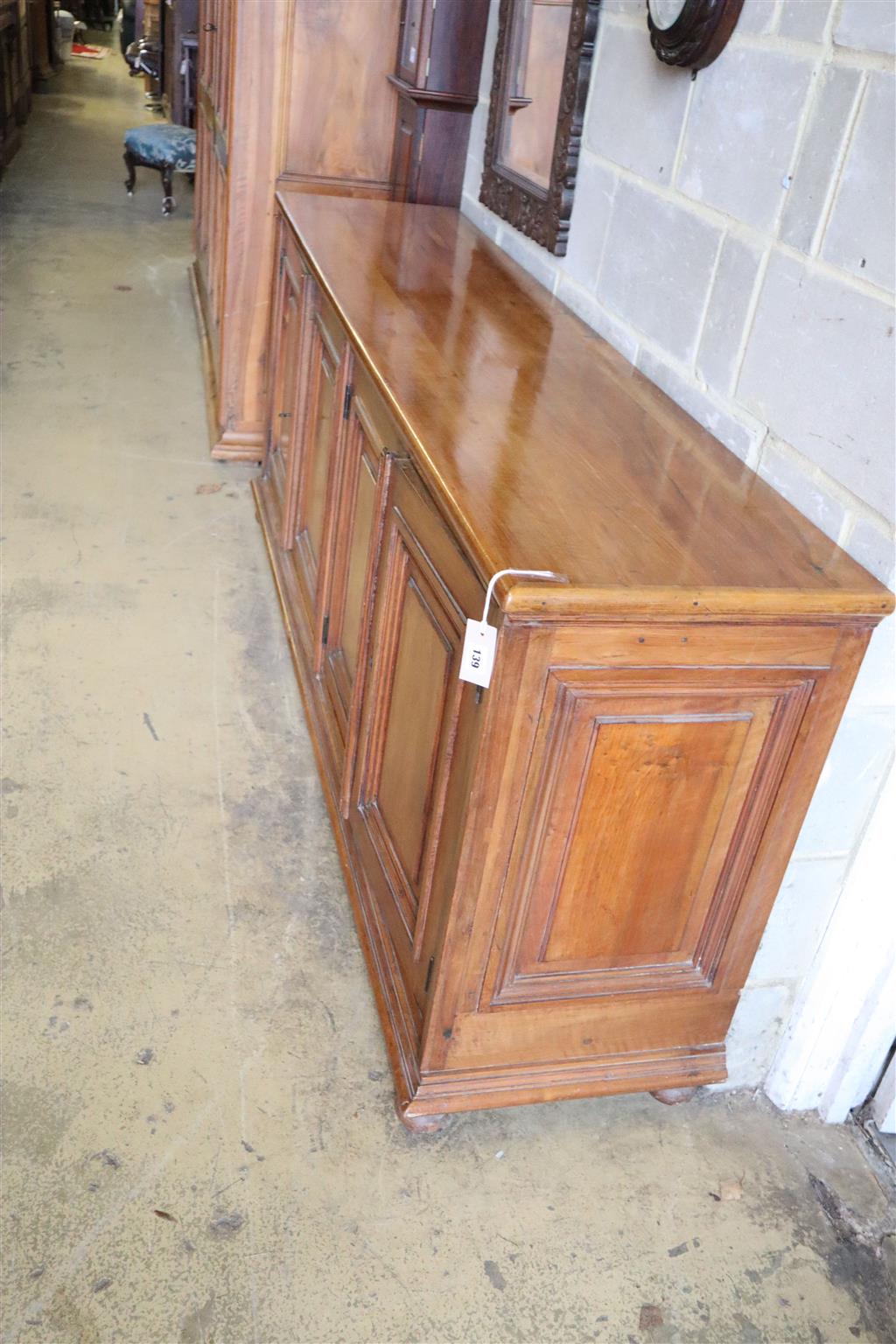 A 19th century French walnut four door panelled cupboard, width 210cm, depth 46cm, height 87cm
